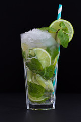 Fresh mojito cocktail on black background. Mojitos with mint leaves, lime and ice