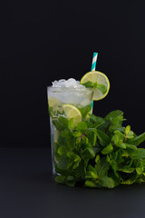 Fresh mojito cocktail on black background. Mojitos with mint leaves, lime and ice