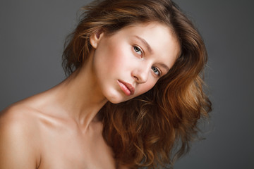 Naklejka premium Portrait of young beautiful woman with bare shoulders and fresh