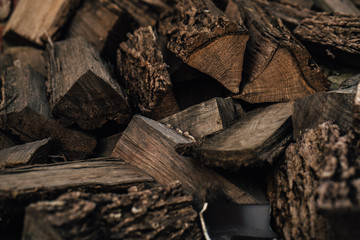 Firewood background - chopped firewood on a stack
