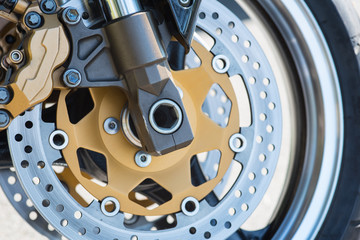 detailed close up of front brakes of a motorcycle