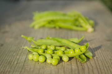 pea pods on wooden table