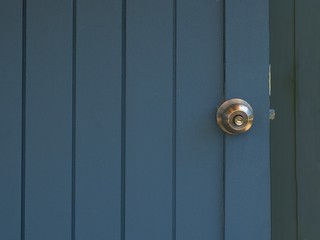 metal handle on a blue vintage wooden door