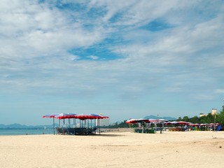 Fototapeta premium Colorful beach chairs and umbrellas for tourism relax in vocation at Cha-Am beach, Thailand