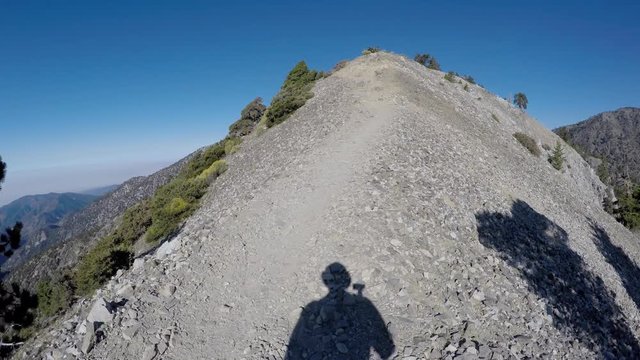 Mt Baldy, California, USA - August 26, 2016:  Devils backbone trail sign time lapse on Mt Baldy in the San Gabriel Mountains above Los Angeles, California.