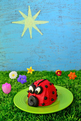 Spring or summer food theme includes a ladybug cupcake, plus the sky and sun drawn on a chalkboard.