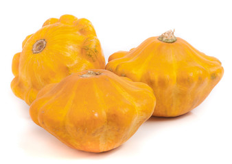 three yellow pattypan squash isolated on white background