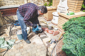 man working in yard puncher