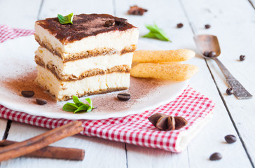 A slice of homemeade tiramisù cake decorated with coffee beans