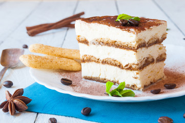 A slice of homemeade tiramisù cake decorated with coffee beans