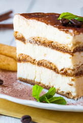 A slice of homemeade tiramisù cake decorated with coffee beans