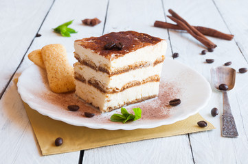 A slice of homemeade tiramisù cake decorated with coffee beans