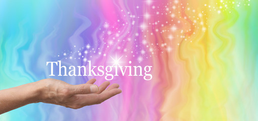 Share your sparkle at Thanksgiving - female hand palm up with THANKSGIVING floating above on a rainbow marble effect background and a stream of sparkles floating upwards - obrazy, fototapety, plakaty