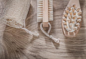 Fototapeta na wymiar Composition of scrubbing loofah massager bath brush on wooden bo