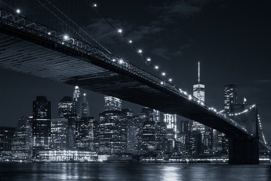 The downtown Manhattan skyline and the Brooklyn Bridge at night