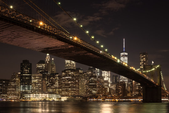 The downtown Manhattan skyline and the Brooklyn Bridge at night
