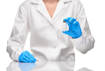 Doctor in gown and gloves holding empty glass ampoule