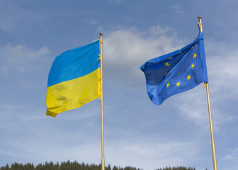 Flags of Ukraine and the European Union are developing on the ba