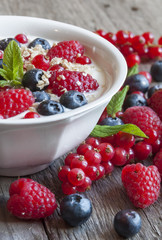 Yogurt with fresh berries in a white bowl