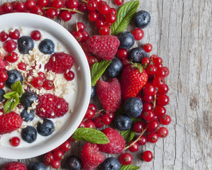 Yogurt with fresh berries in a white bowl
