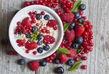 Yogurt with fresh berries in a white bowl