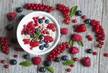 Yogurt with fresh berries in a white bowl © Maresol