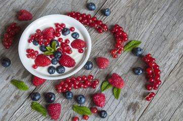 Yogurt with fresh berries in a white bowl