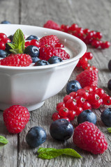 Yogurt with fresh berries in a white bowl