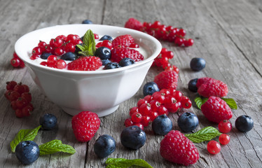 Yogurt with fresh berries in a white bowl