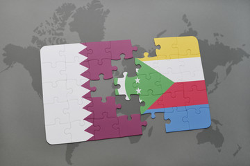 puzzle with the national flag of qatar and comoros on a world map background.