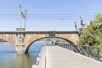 Obraz premium riverside walkway and railway border bridge in Hendaye in the French Basque Country, France 