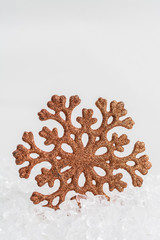 Golden snowflake on white chrystal background