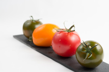 Ripe colorful red, yellow and green kumato tomatoes