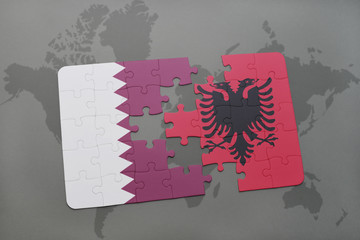 puzzle with the national flag of qatar and albania on a world map background.