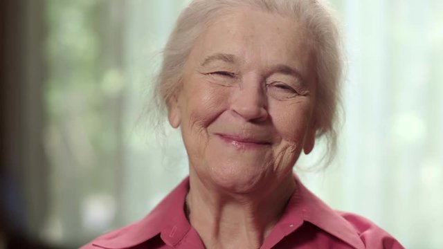 Close up of a happy elderly senior woman smiling. Shot in 4K UHD.