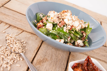 Spinach, dried tomatoes, feta cheese and sunflower seeds salad