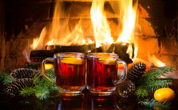 Mulled wine or hot drink, christmas decoration, fireplace
