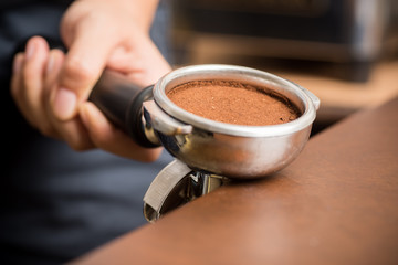 Ground coffee in a portafilter ready to making coffee