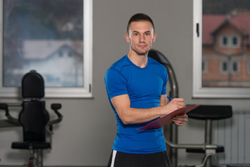 Caucasian Instructor Takes Notes On Clipboard