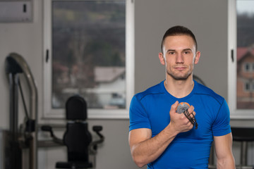 Man Working With Stopwatch In A Fitness Center