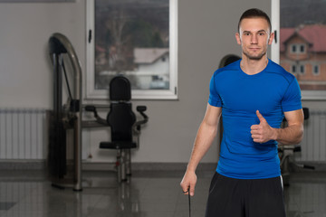 Fototapeta na wymiar Personal Trainer Showing Thumbs Up Sign