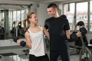 Fit Couple Together Training Biceps With Dumbbells