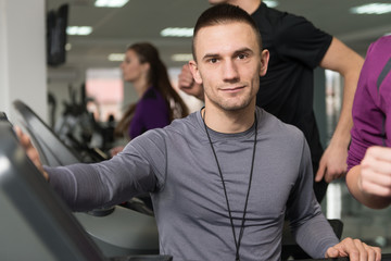 Fototapeta na wymiar Group Of People Running On Treadmills In Gym