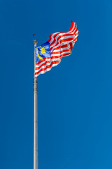 Wavy Malaysian flag on clear deep blue sky