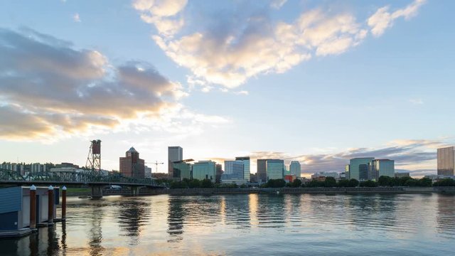Ultra high definition 4k time lapse movie of moving clouds over downtown city skyline of Portland Oregon along Willamette River with Hawthorne bridge at sunset into blue hour 4096x2304