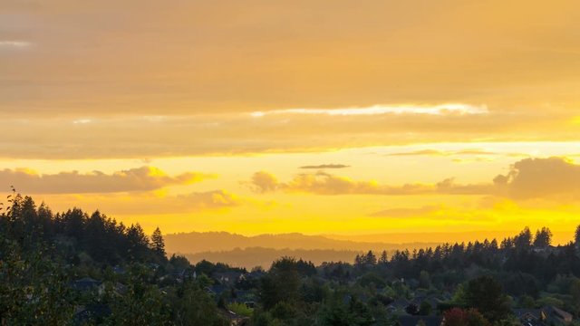 UHD 4k Time lapse movie of clouds and golden sky over residential suburb homes in Happy Valley Oregon at sunset into blue hour 4096x2304