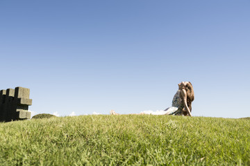 Young women are relaxing on the lawn of the park