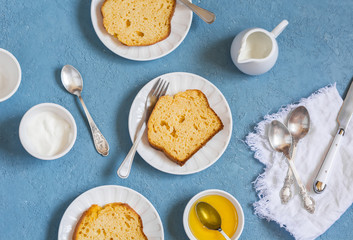 Slices of pumpkin cake on white plates on a blue background.  Delicious autumn dessert.