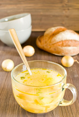 soup in clear soup mug on wooden table