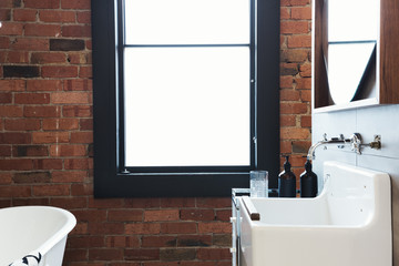 Vintage warehouse bathroom conversion with large blank window for text